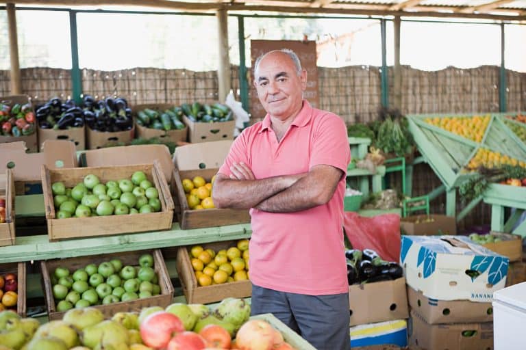 Market trader at fruit and vegetable stall